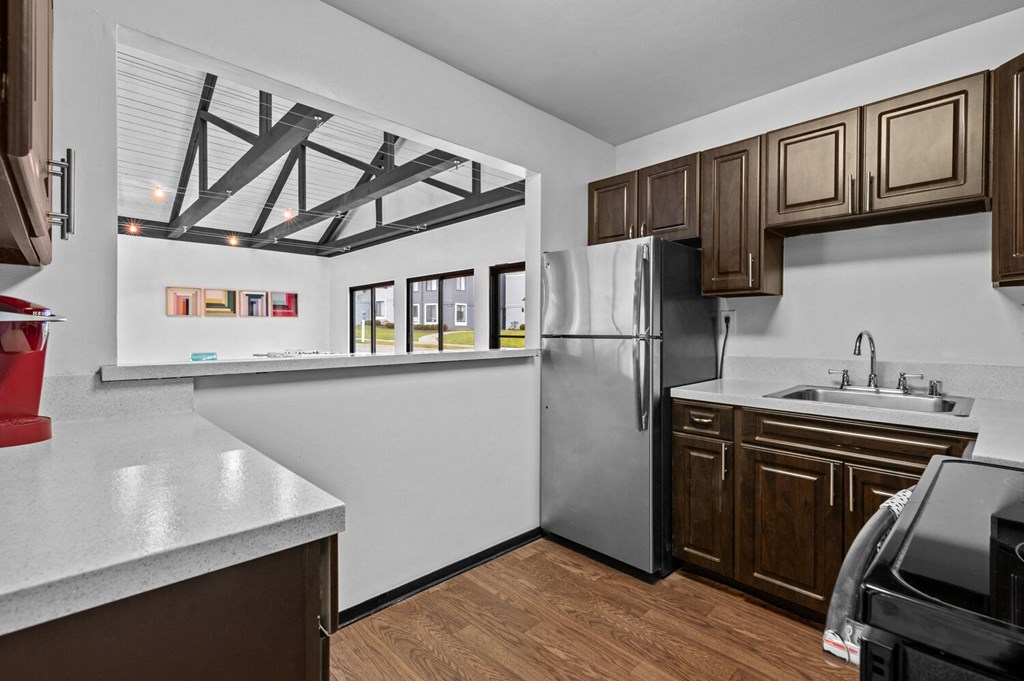the kitchen of a home with a stainless steel refrigerator and a sink