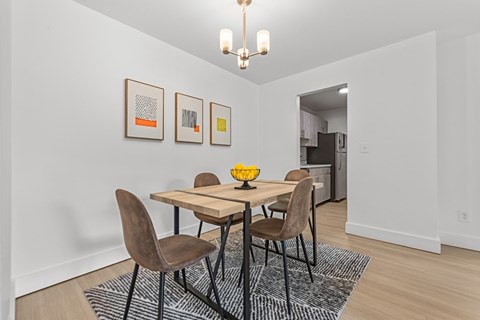 A dining room with a table and chairs.