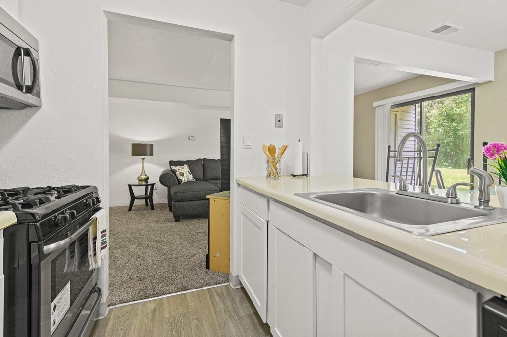a kitchen with a sink and a stove and a window