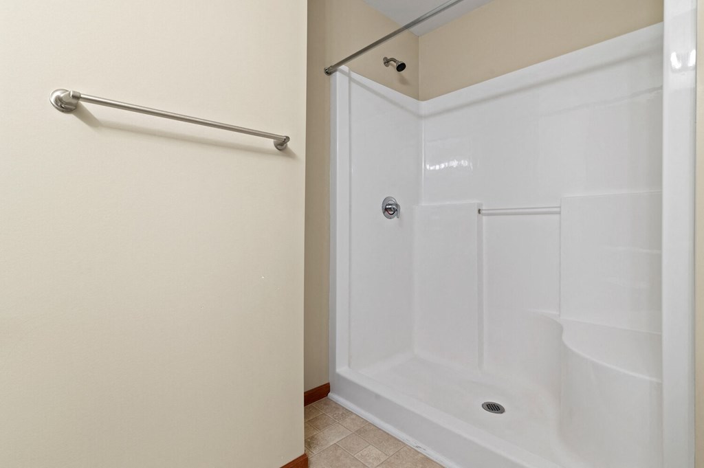 a bathroom with a white shower and a sliding door