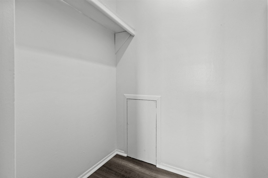 an empty room with white walls and a white door at Sunnymede Apartments - Troy, MI, Michigan