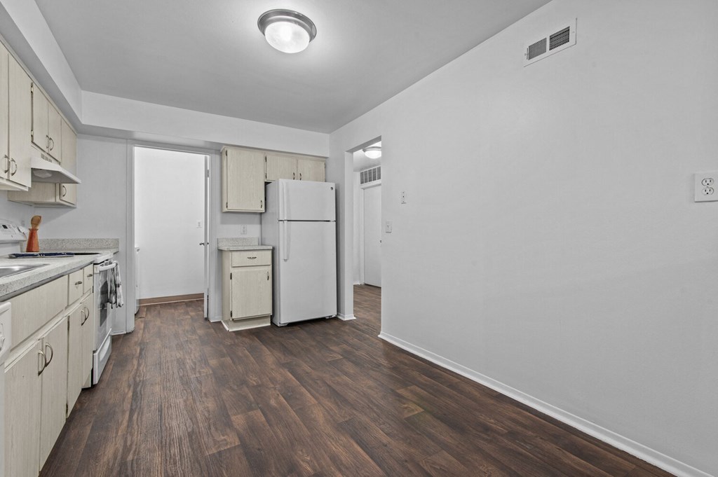 an empty kitchen with white cabinets and a white refrigerator at Edge At Farmington Hills - Farmington Hills, MI, Michigan, 48334