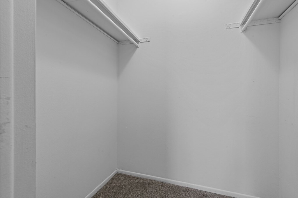 A small, empty room with a carpeted floor and white walls.