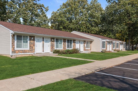 a white house with white doors and a sidewalk