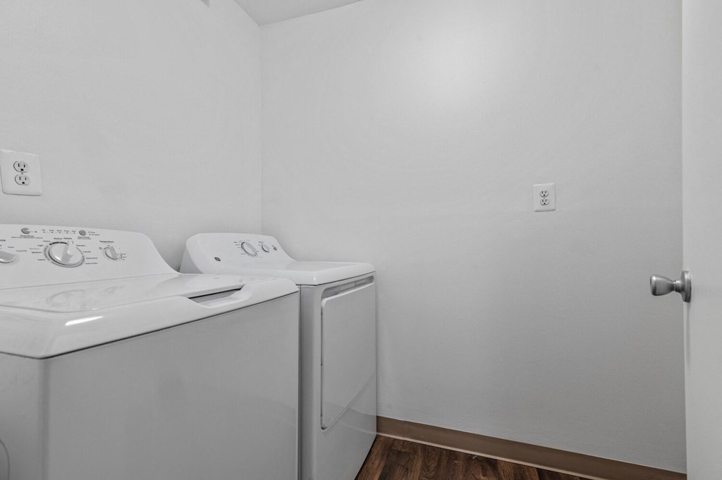 an empty laundry room with a washer and dryer and white walls at Edge At Farmington Hills - Farmington Hills, MI, Farmington Hills, Michigan