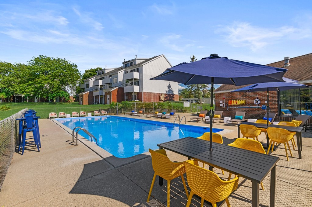 our apartments have a resort style pool with chairs and umbrella