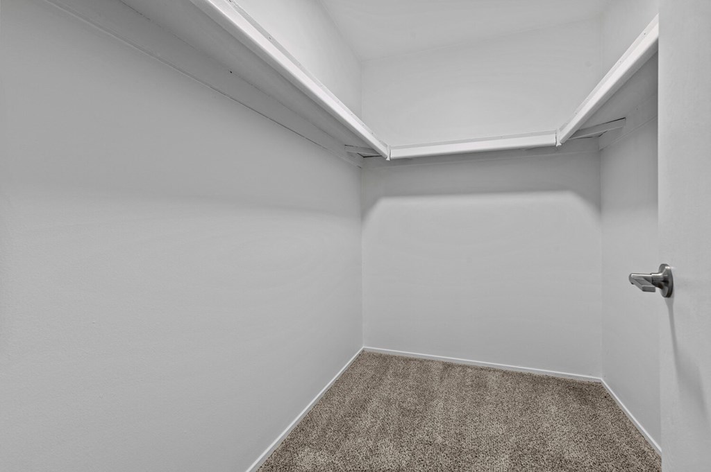 a small room with a carpeted floor and a white door