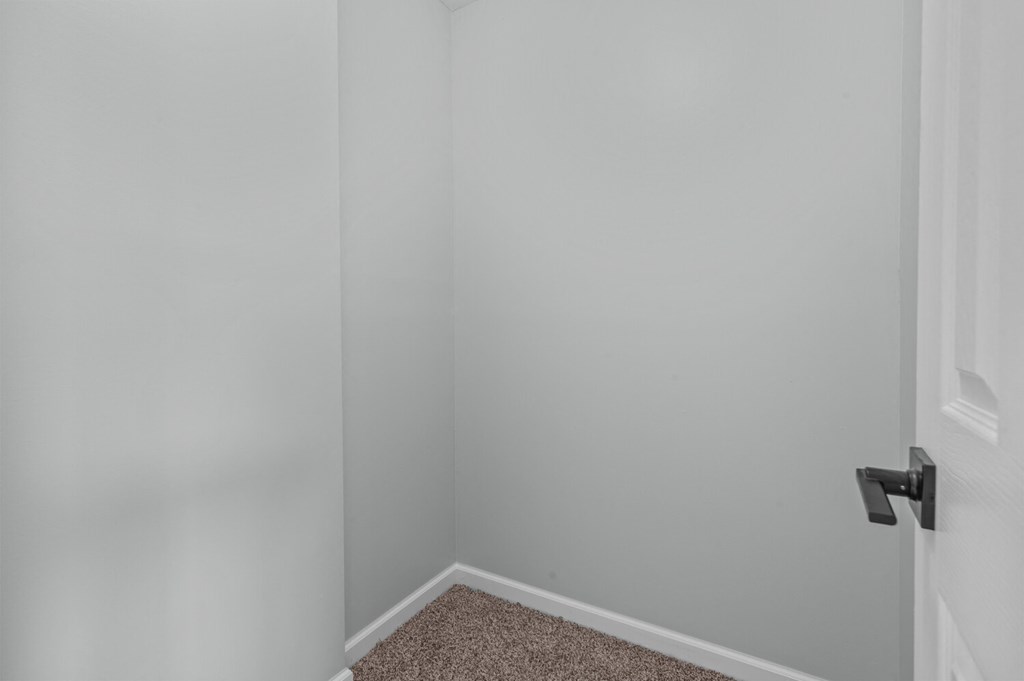 an empty room with white walls and a door