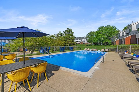 A pool area with a table and chairs.