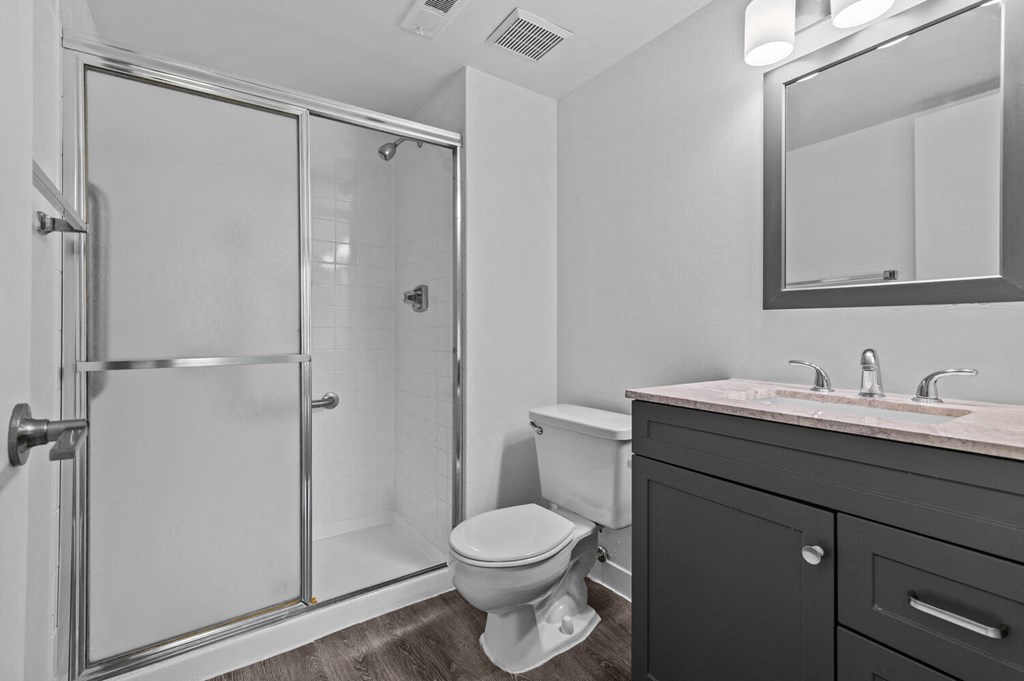 a bathroom with a toilet sink and shower