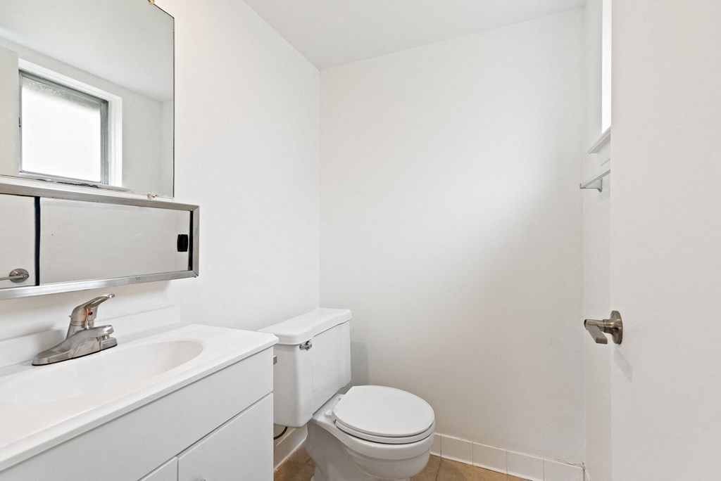 an empty bathroom with a toilet and a sink