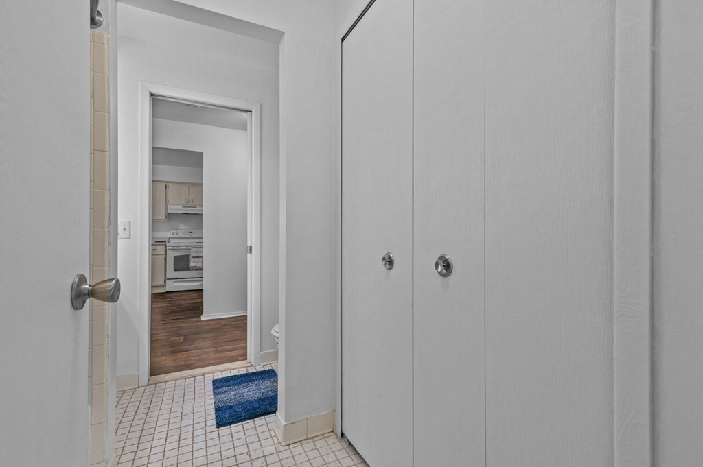 a bedroom with white closets and a door to a kitchen at Edge At Farmington Hills - Farmington Hills, MI, Farmington Hills, Michigan