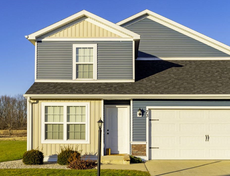 a gray house with a white garage door