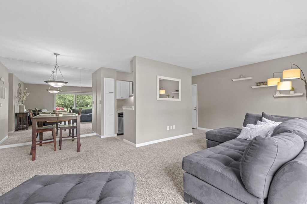 a living room with a couch and a chair at Apple Ridge Apartments - Livonia, MI, Michigan