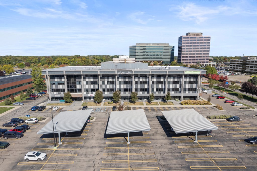 an aerial view of a parking lot in front of a large building