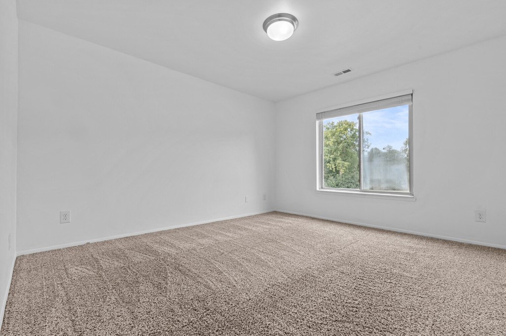 an empty room with carpet and a window at Edge At Farmington Hills - Farmington Hills, MI, Farmington Hills, 48334