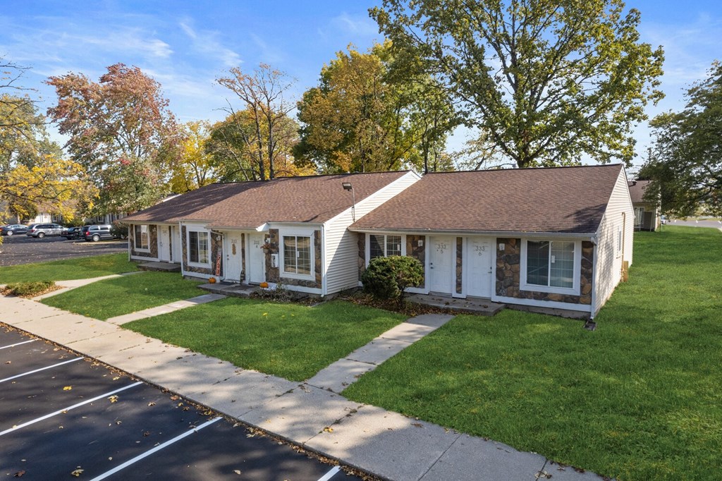 a small white house on the side of a street