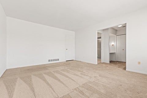 a living room with carpet and white walls