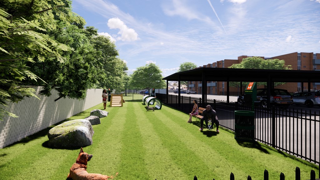 A dog is sitting on the grass in a park.