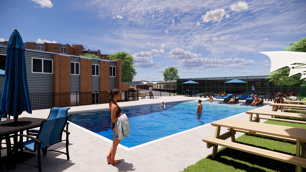 A woman is standing by a pool on a sunny day.
