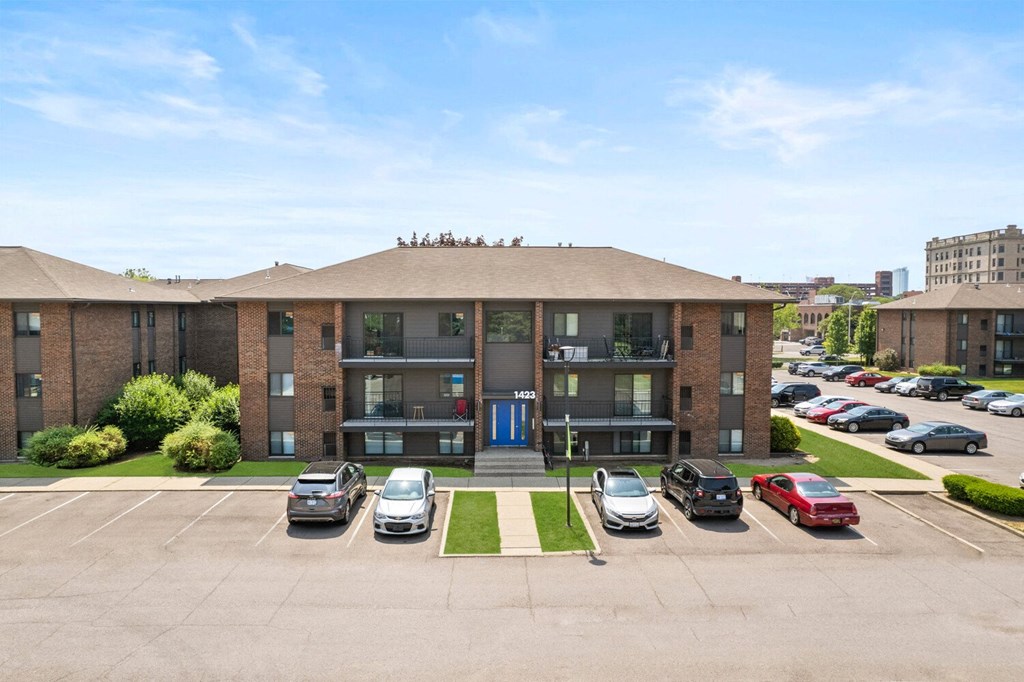 a large brick apartment building with a parking lot in front of it at Lafayette Park Place, Detroit, MI, Detroit, MI