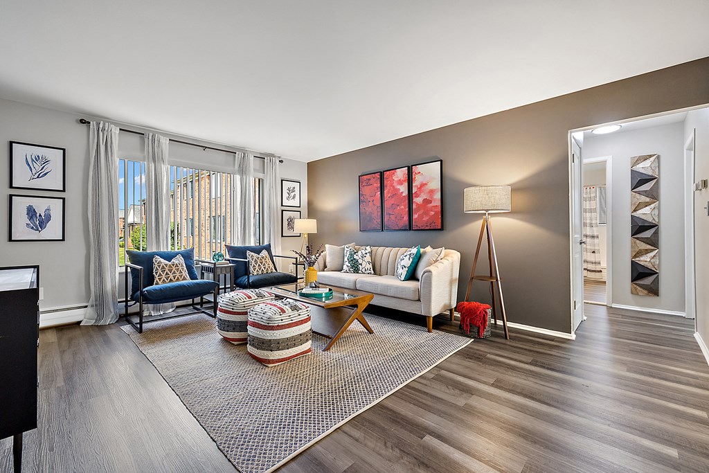 spacious living room with wood flooring and windows at the reserve apartments