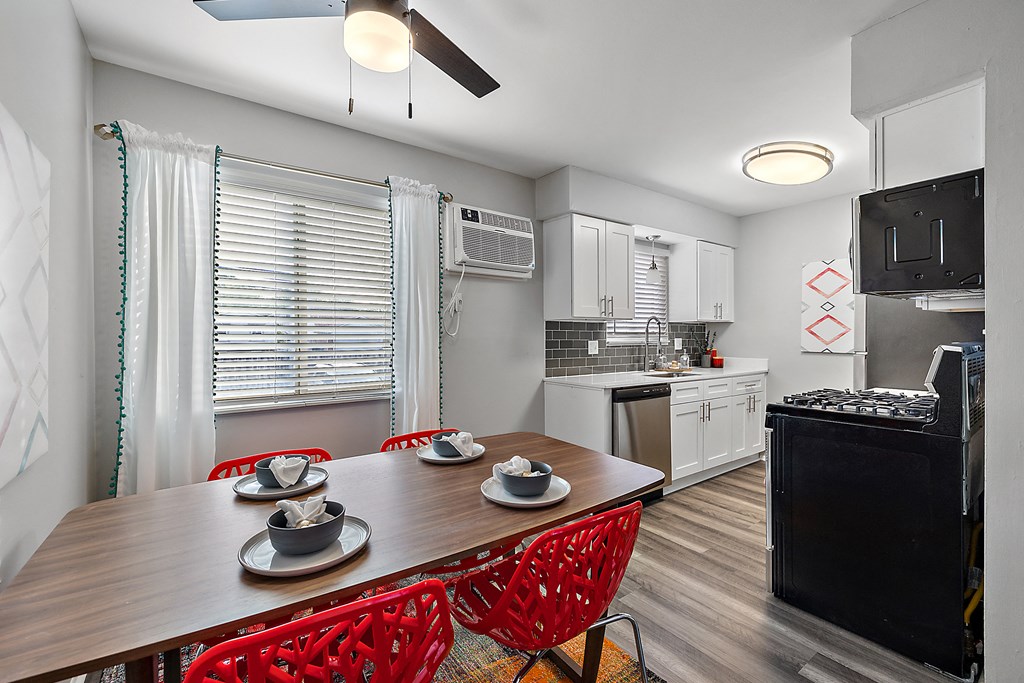 a kitchen and dining room with a wooden table and chairs