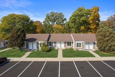 a house with a lawn and a parking lot