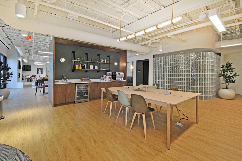 A modern office space with wooden floors and furniture.