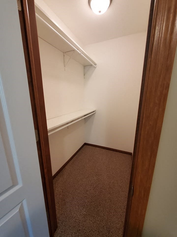 a room with a closet and a shelf