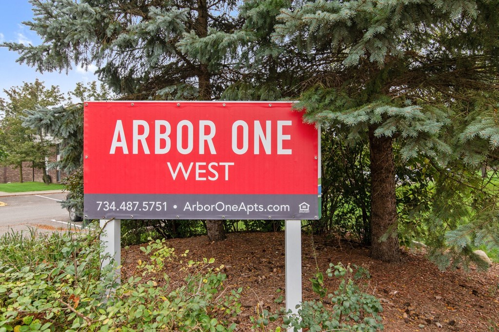 a sign that reads arbor one west in front of trees