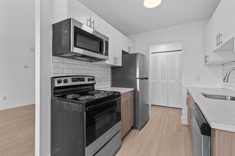 a kitchen with stainless steel appliances and a microwave