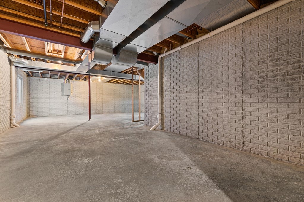 a large room with brick walls and a concrete floor