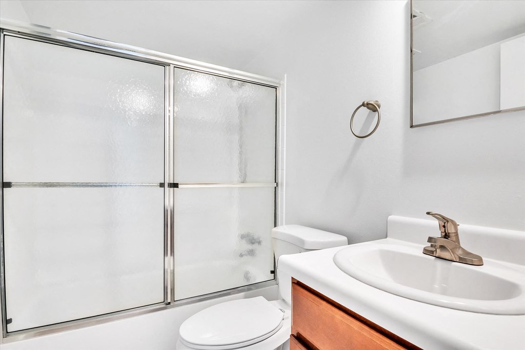 a bathroom with a sink toilet and shower