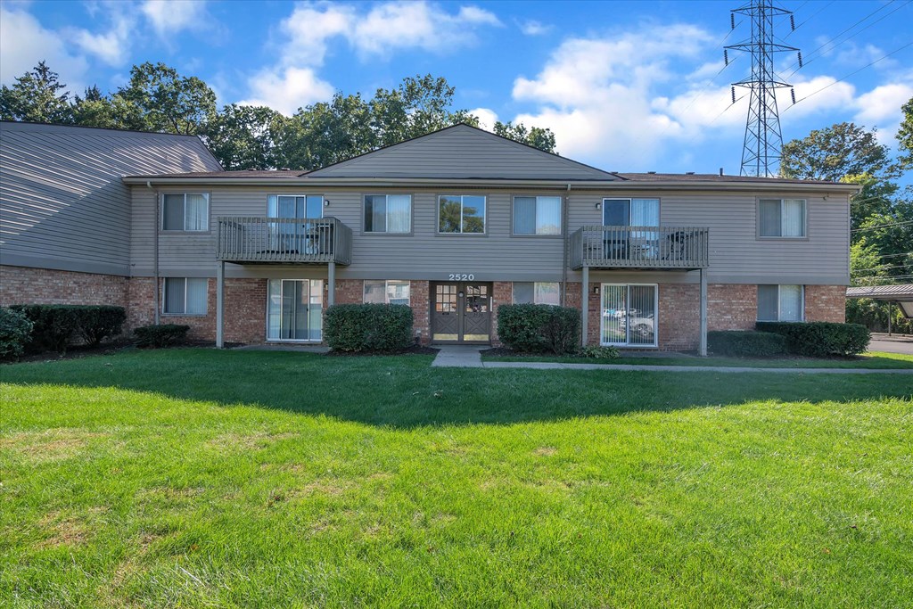 a large house with a lawn in front of it