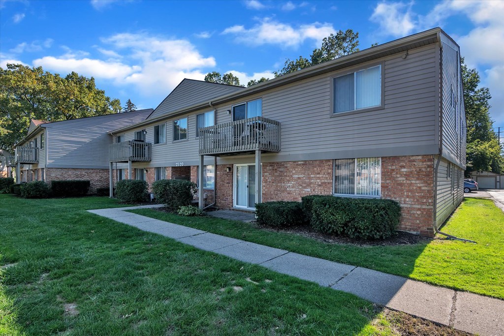 a brick and with a sidewalk in front of it