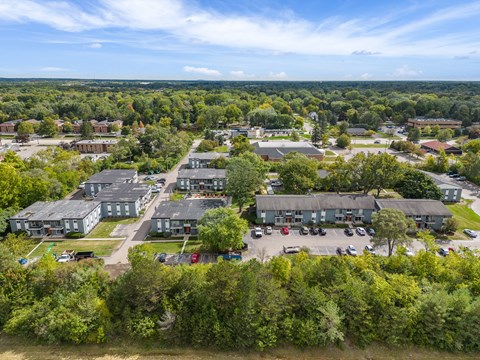 A bird's eye view of a residential area with houses and cars.