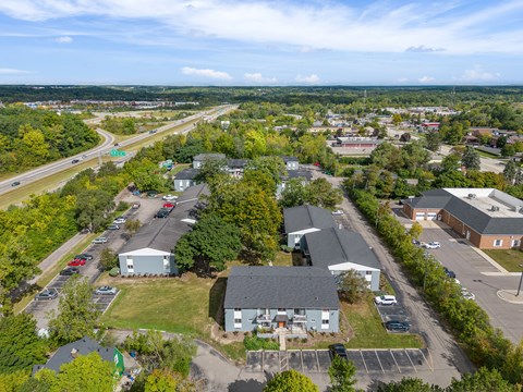 A bird's eye view of a small town with a road running through it.