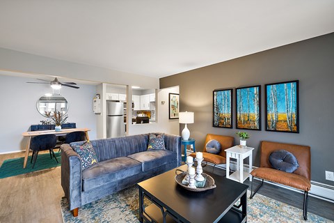 A living room with a blue couch and a black coffee table.