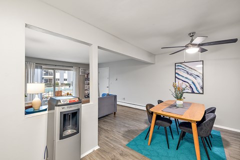 A dining room with a table and chairs.