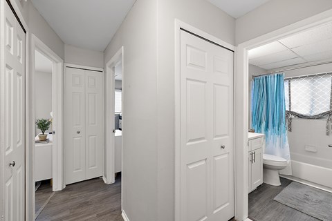 A white bathroom with a blue shower curtain.