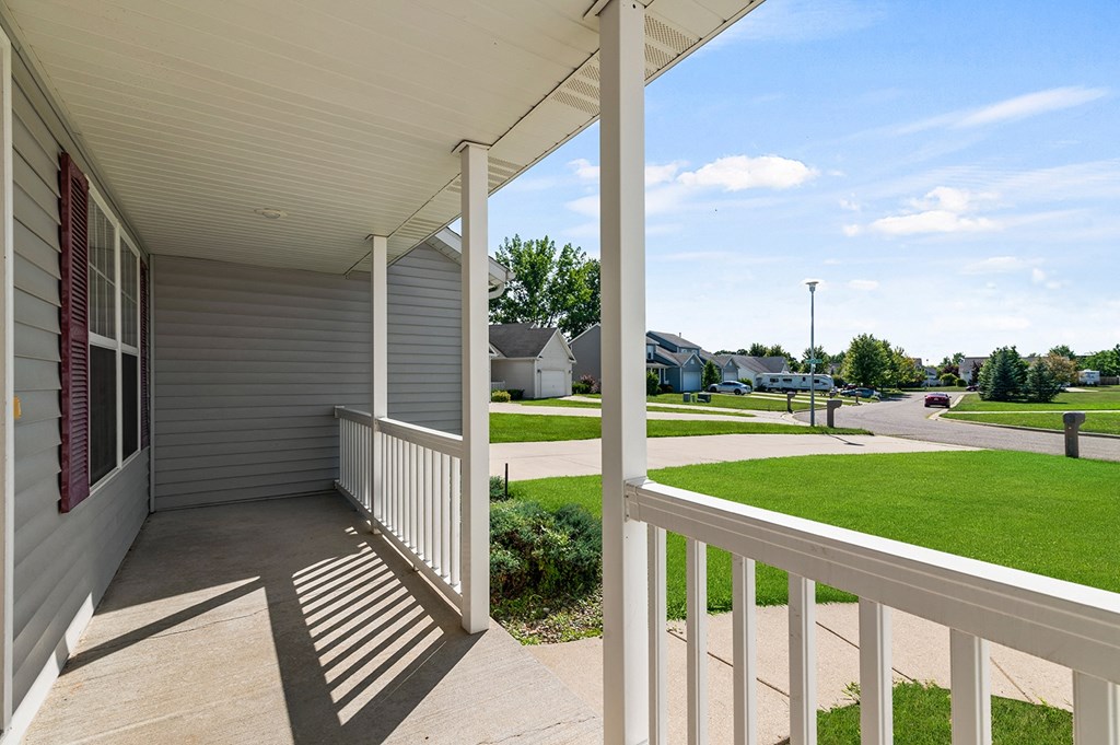 the view from the front porch of a home with a porch swing