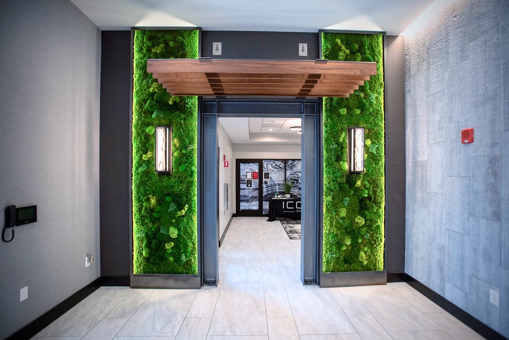 a lobby with a green wall with moss on it
