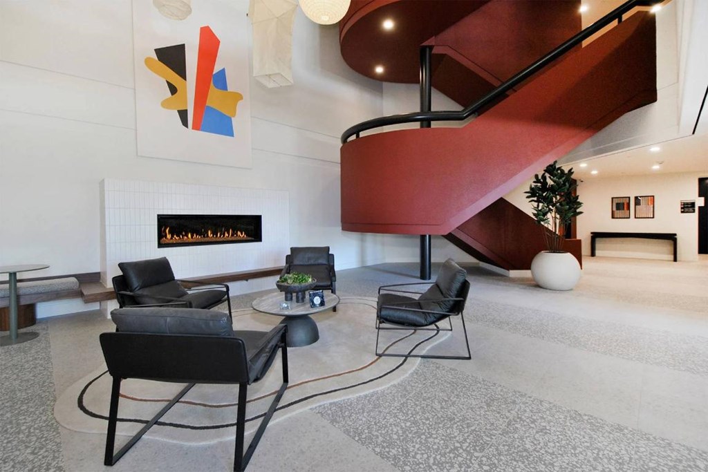 A living room with a spiral staircase and a sign that says "Welcome".