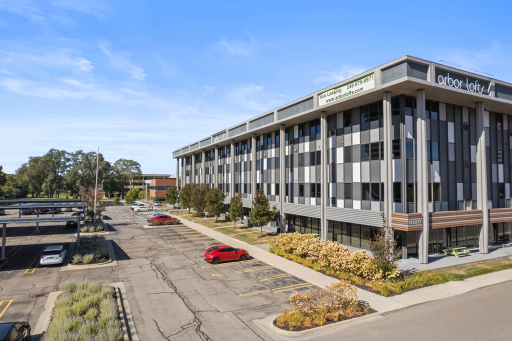 an office building with a parking lot in front of it