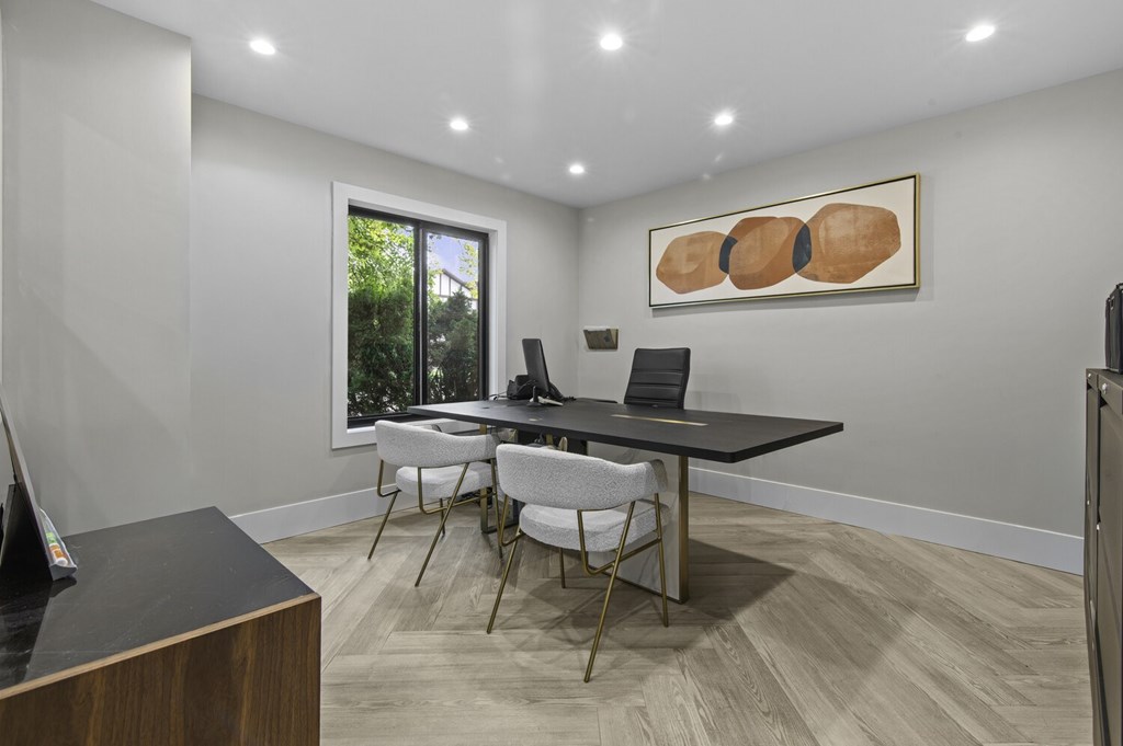 A conference room with a long table and chairs.