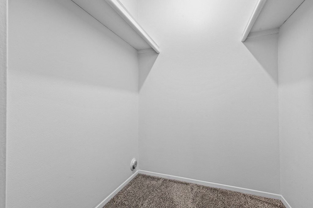 a small room with white walls and carpet