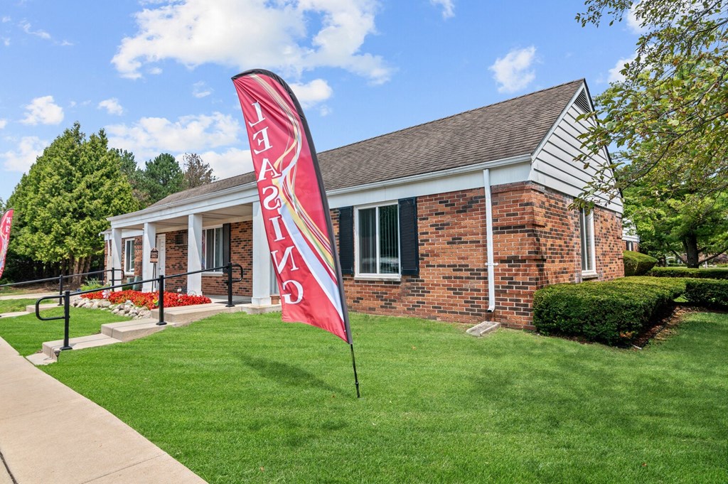 a flag in front of a building at Apple Ridge Apartments - Livonia, MI, Livonia, Michigan