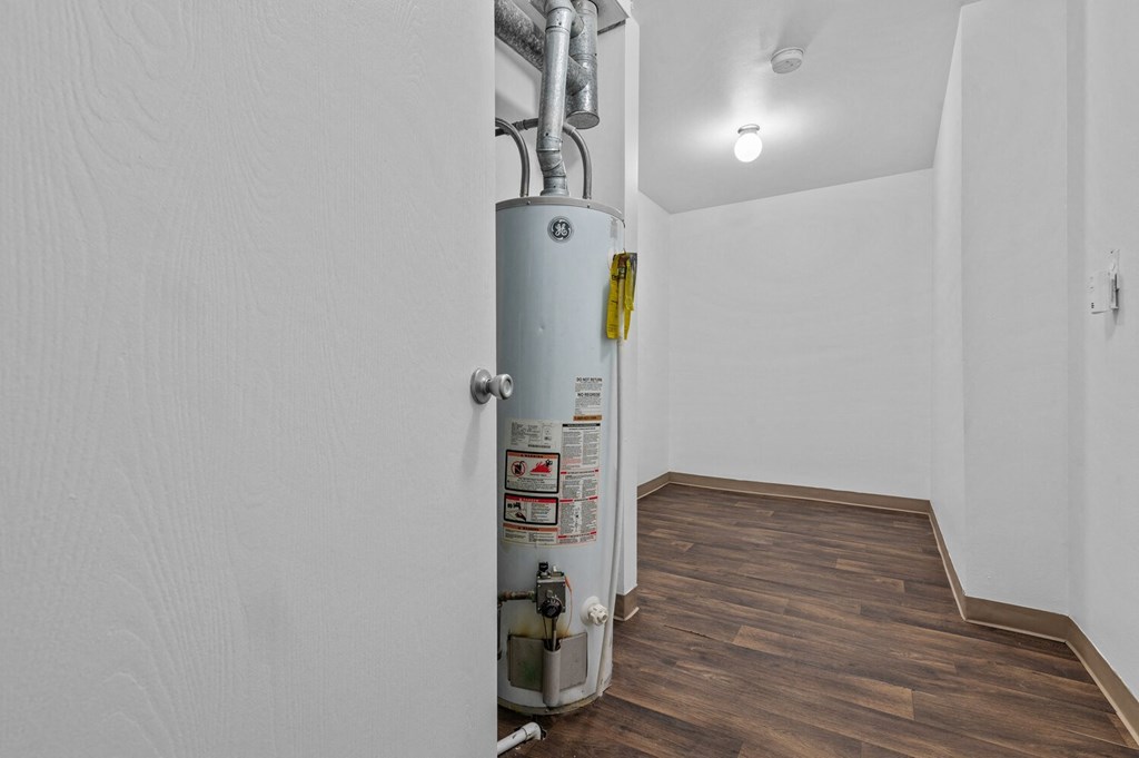 a white room with a gas heater in the corner at Edge At Farmington Hills - Farmington Hills, MI, Farmington Hills, MI