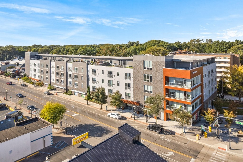 a view from the top of a building of a city street with trees in the background